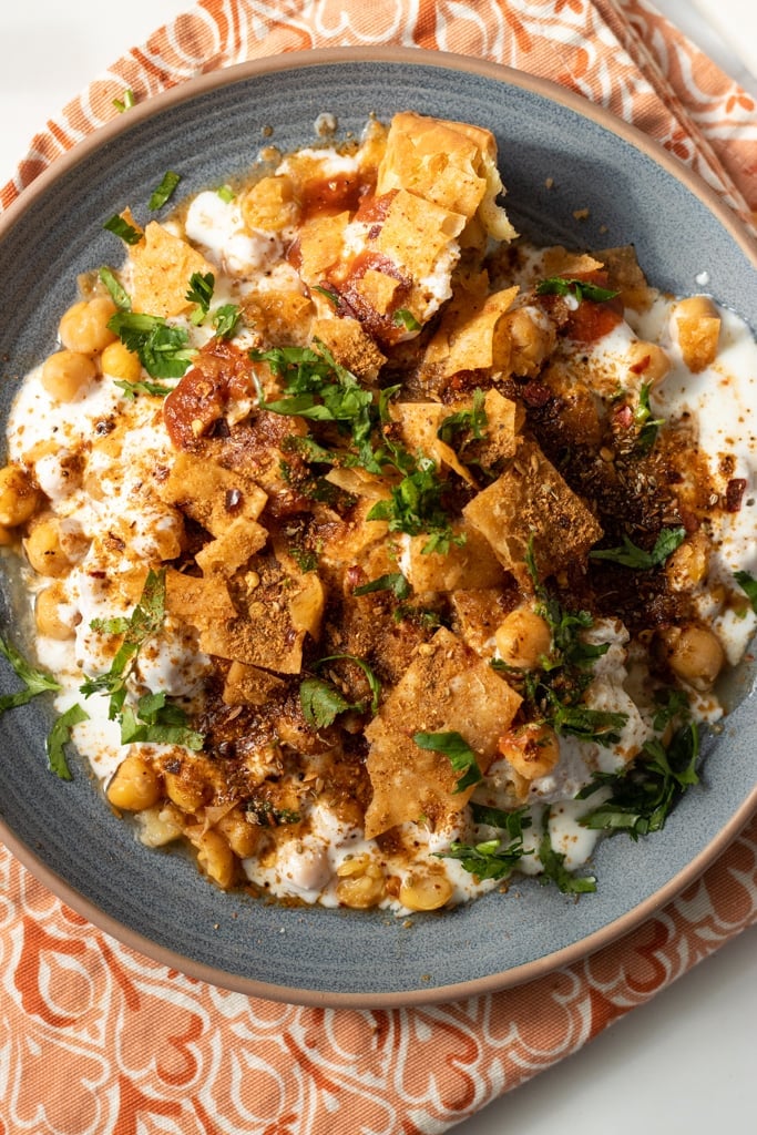 Samosa chaat topped with yogurt, tamarind chutney, mint chutney and chaat masala